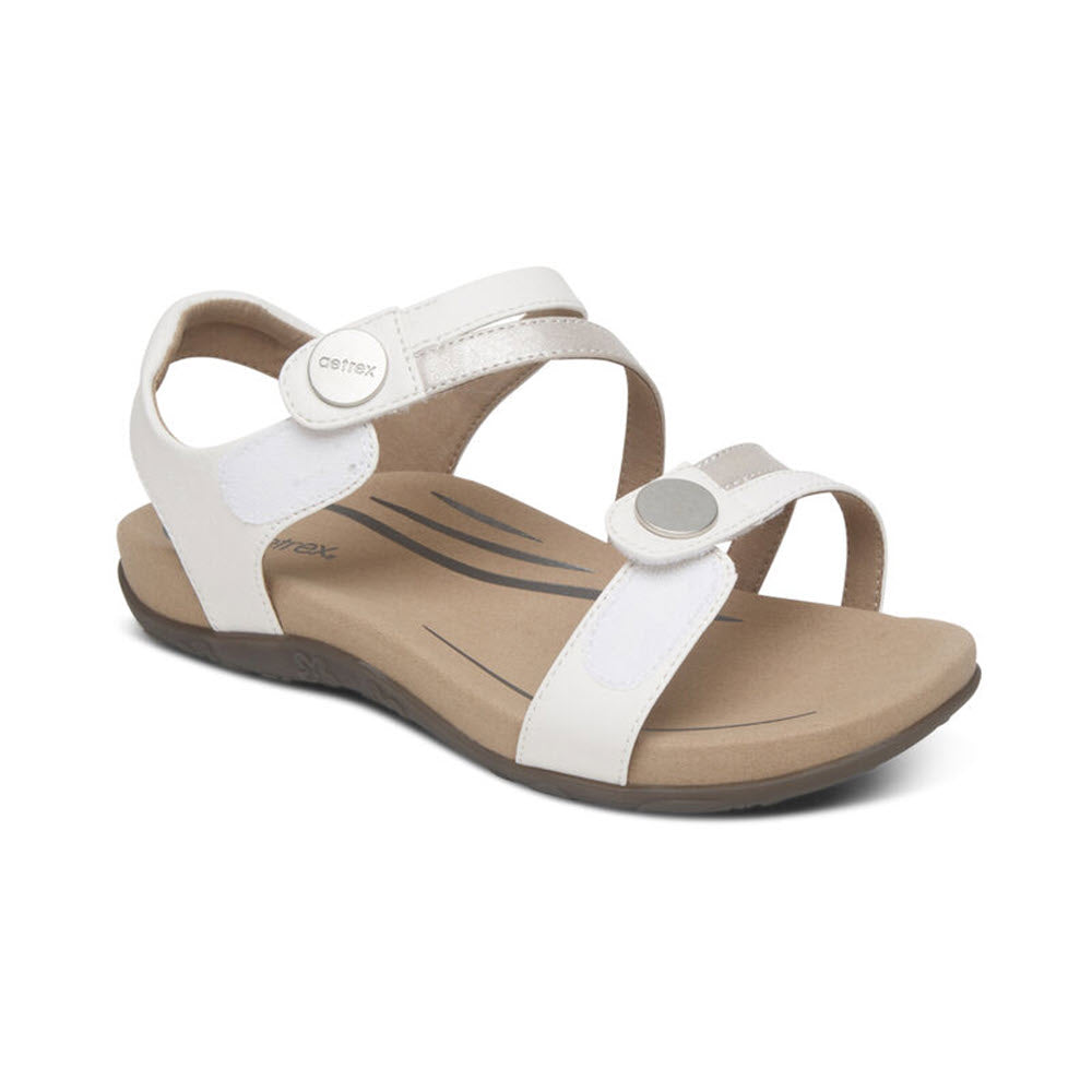 A white, open-toe adjustable sandal with arch support and a cushioned beige footbed, the **AETREX JESS WHITE - WOMENS** from **Aetrex**.