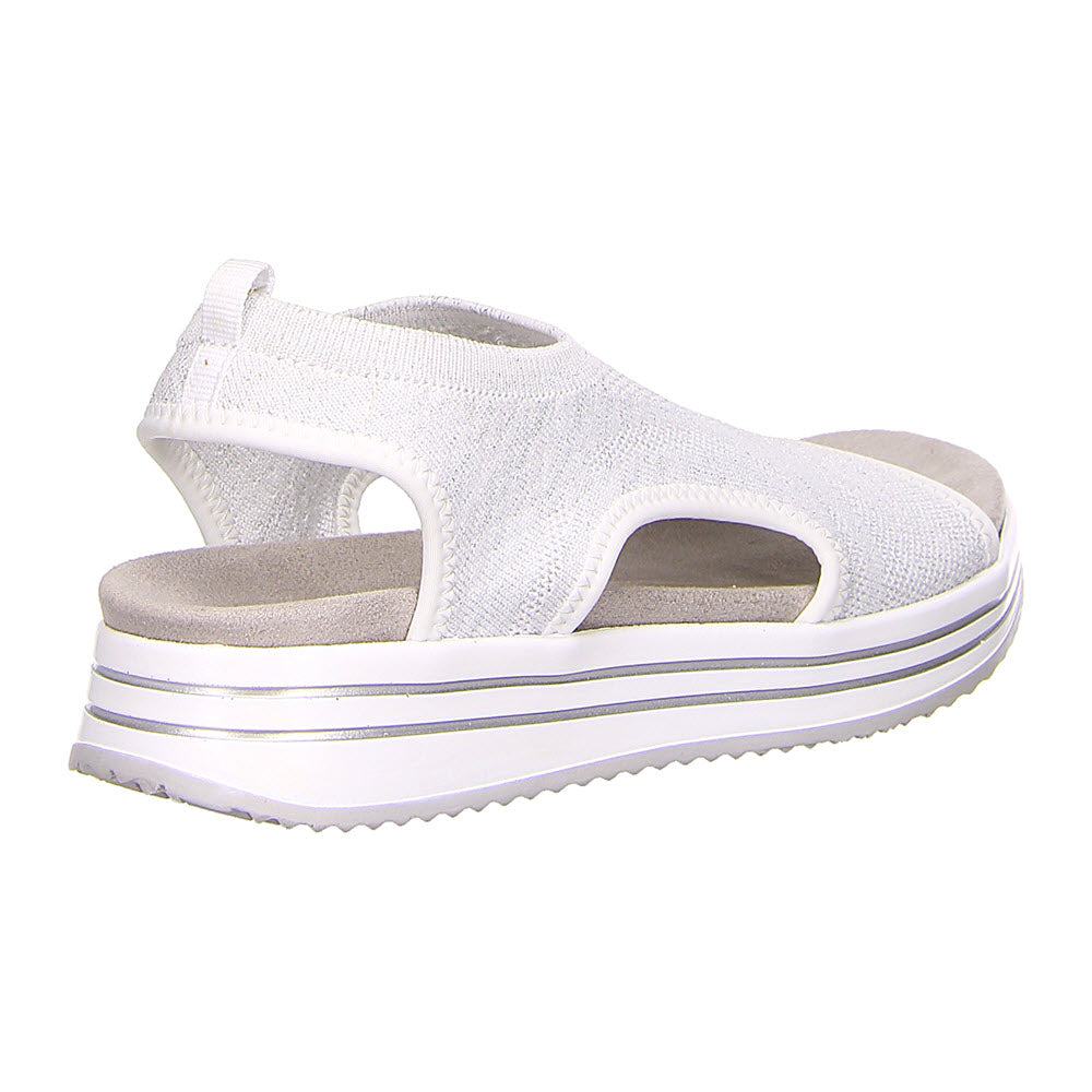 The REMONTE ATHLEISURE KNIT SANDAL WHITE - WOMENS by Remonte is a sporty chic sandal featuring an open-toe design, a stretch knit upper, and a thick, grooved platform sole. An elastic strap at the back provides additional support.