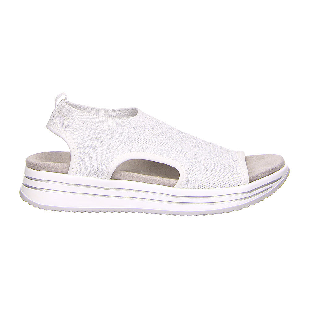 Side view of the REMONTE ATHLEISURE KNIT SANDAL WHITE - WOMENS from Remonte, showcasing an open-toe design with a knit upper material featuring cut-out details, a thick rubber sole for comfort and support, and a Remonte Soft removable footbed for enhanced ease.