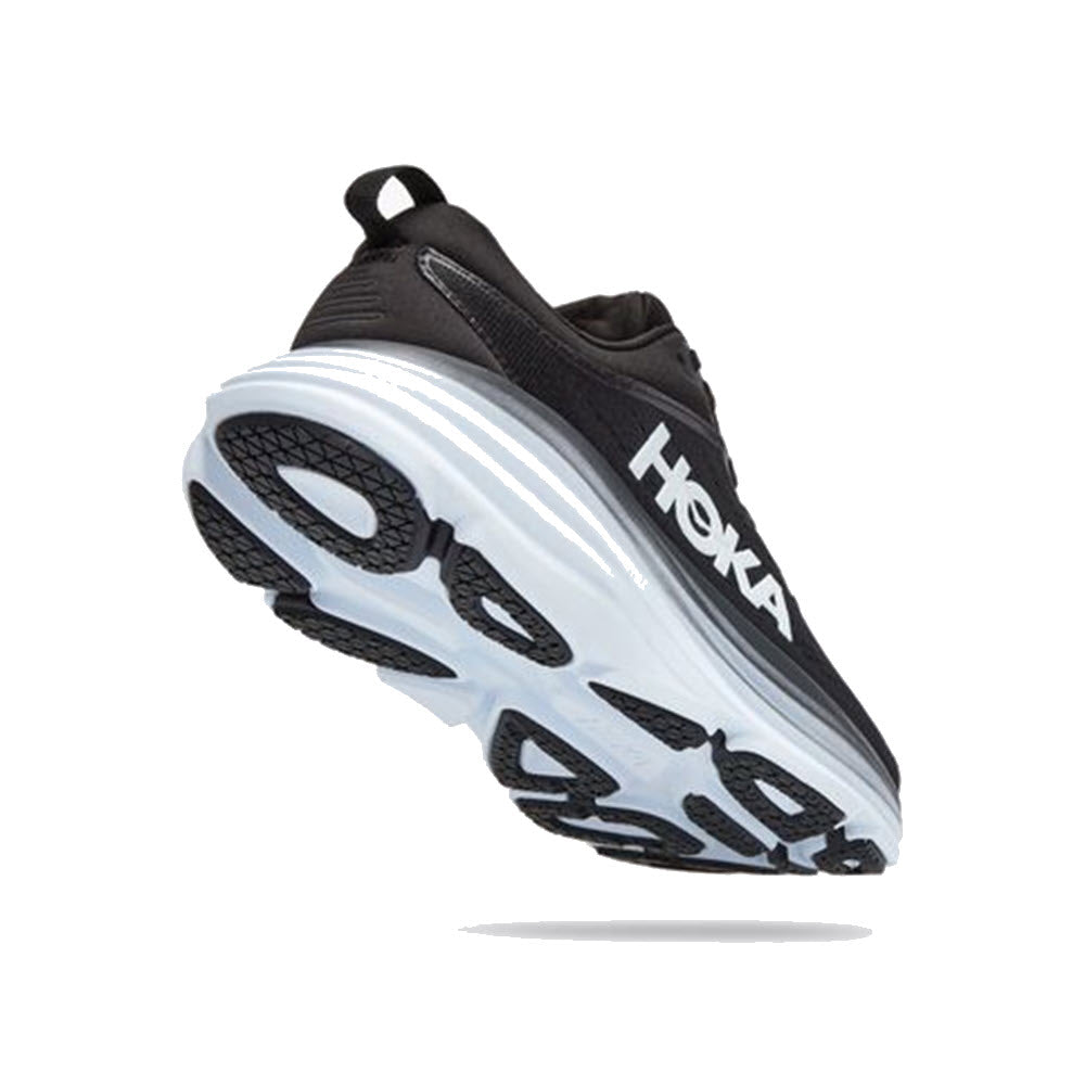 A black and white athletic shoe with a thick sole and visible tread is shown, featuring the brand name &quot;HOKA ONE ONE BONDI 8 BLACK/WHITE - WOMENS&quot; on the side. The ultra-cushioned design promotes foot health for maximum comfort during any activity.