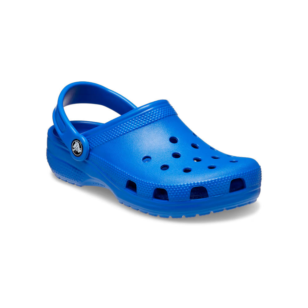 A single Crocs Classic Clog Blue Bolt for kids, featuring a perforated top, heel strap, and a logo button on the side, delivering Iconic Crocs Comfort.