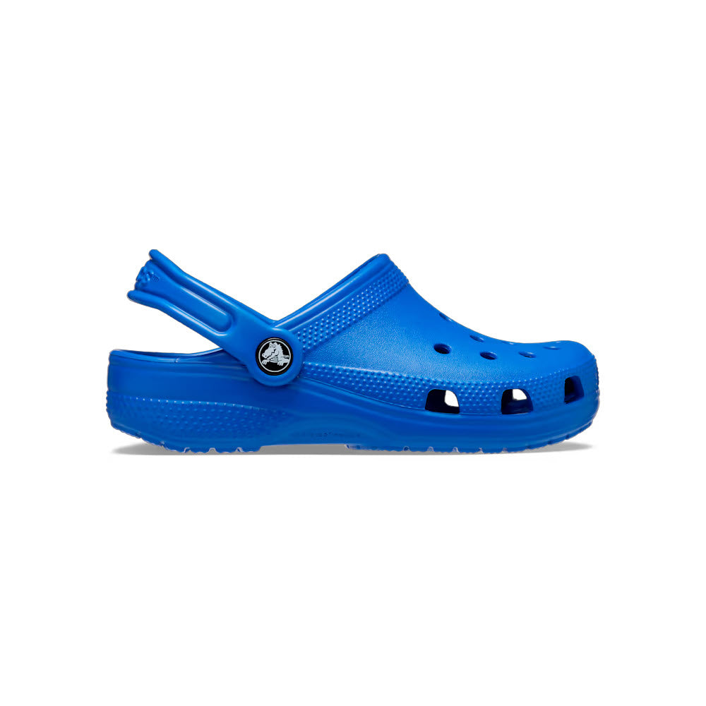 A side view of the Crocs Classic Clog Blue Bolt - Kids features ventilation holes and an adjustable heel strap, showcasing the Iconic Crocs Comfort.