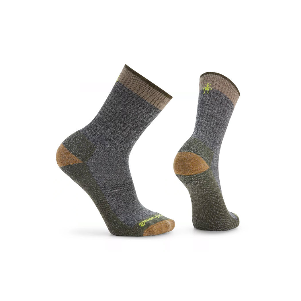 Two gray and brown Smartwool SMARTWOOL ROLLINSVILLE CREW SOCKS FOSSIL - MENS, one standing upright and one at an angle, showcasing reinforced heel and toe areas.