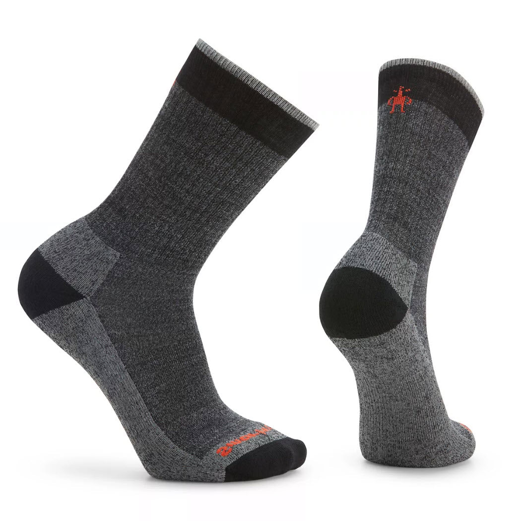 Pair of gray and black SMARTWOOL ROLLINSVILLE CREW SOCKS BLACK - MENS with reinforced toes and heels. The comfortable socks have a small red logo near the cuff and &#39;Smartwool&#39; branding on the toes.