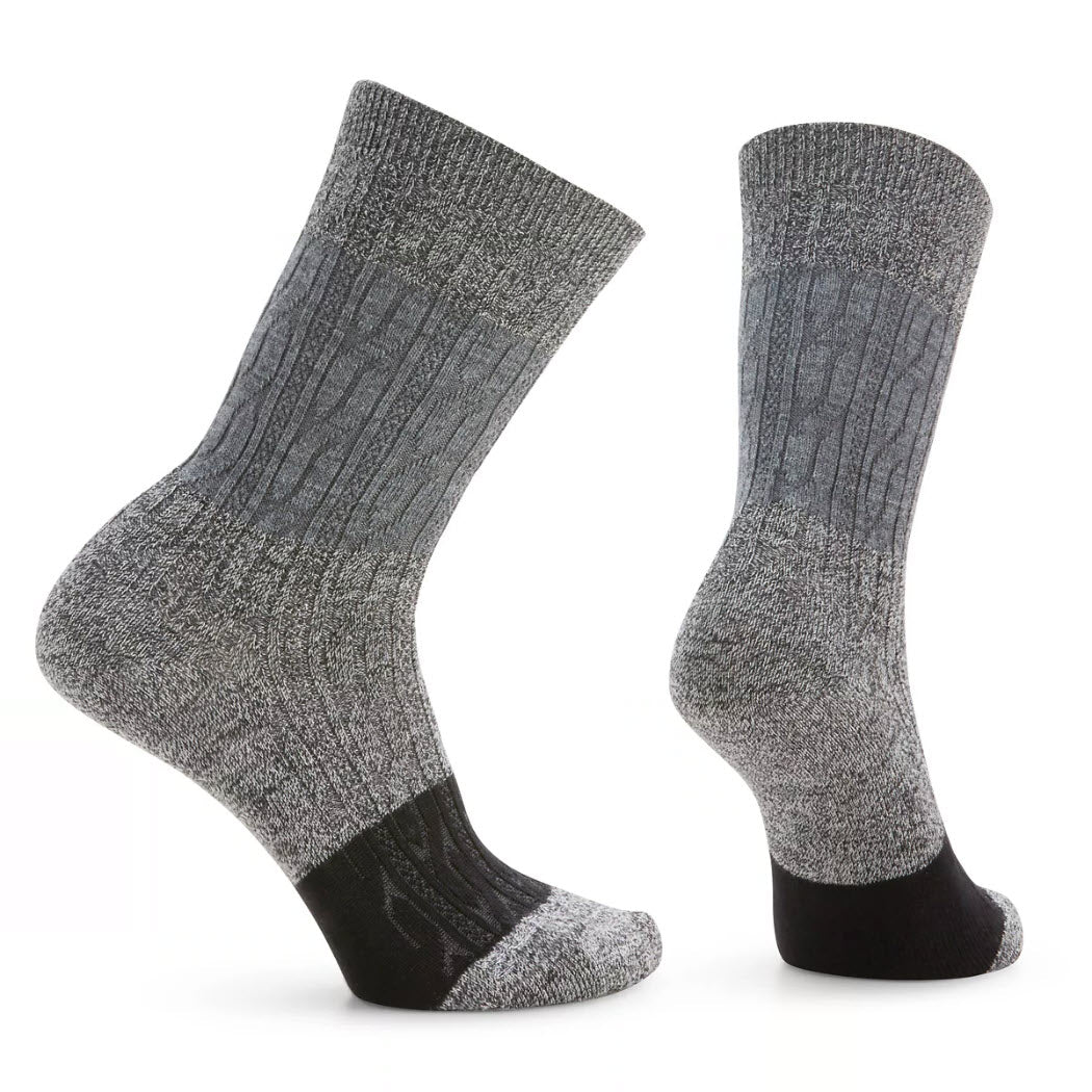 Two grey, mid-calf Smartwool Colorblock Cable Crew Socks Charcoal from Smartwool are displayed, one in a vertical position and the other slightly bent. Made from soft Merino wool, they feature a textured pattern with a black section at the heel and toe, along with a Virtually Seamless toe for enhanced comfort.