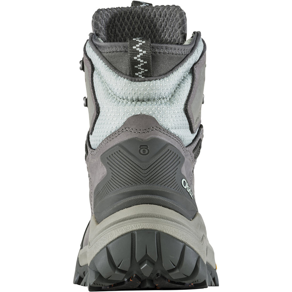 Back view of a gray insulated waterproof hiking boot, the Oboz OBOZ BANGTAIL MID INSULATED BDRY WINTER QUARTZ - WOMENS, perfect for winter weather, showing detailed stitching, padded collar, and rugged sole.