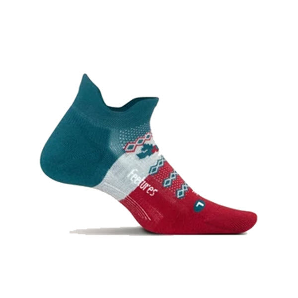 A colorful anklet sock featuring a teal heel and upper, white stripes, red toe section, and geometric patterns with blue, white, and red accents. With Elite Light Cushion for comfort and targeted compression for support, the word &quot;Feetures&quot; is visible on the side. This product is known as FEETURES NO SHOW SOCKS MISELTOE - WOMENS by the brand Feetures.