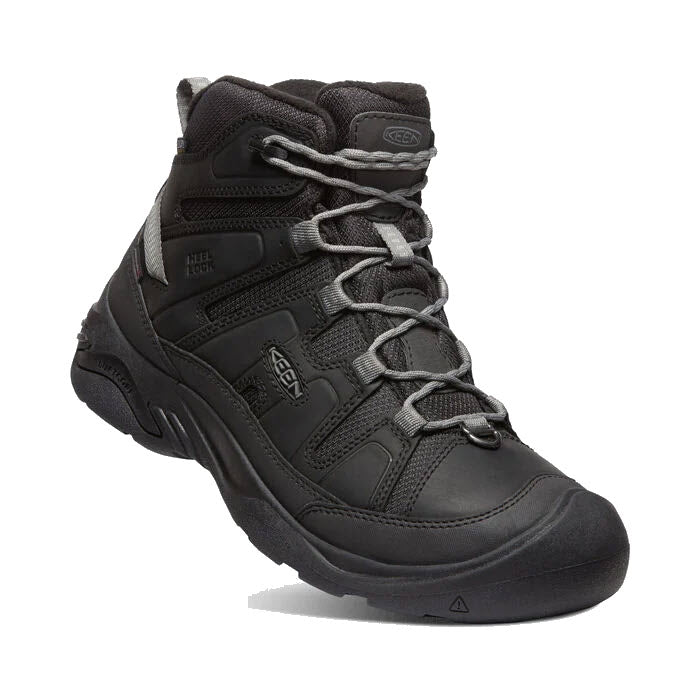 The KEEN CIRCADIA MID POLAR 200 GM STEEL - MENS, a single black outdoor hiking boot accented with grey laces, features a sturdy rubber sole and enhanced ankle support, ensuring warmth with its insulation and waterproof construction. It is displayed against a white background.