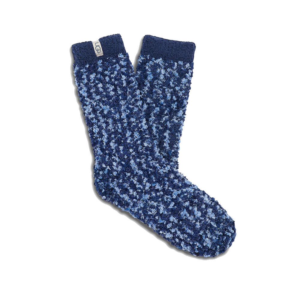 A pair of UGG COZY CHENILLE CREW SOCKS NAVY - WOMENS by Ugg with varying shades of blue and a small tag on one sock&#39;s cuff, featuring a confetti-like pattern.