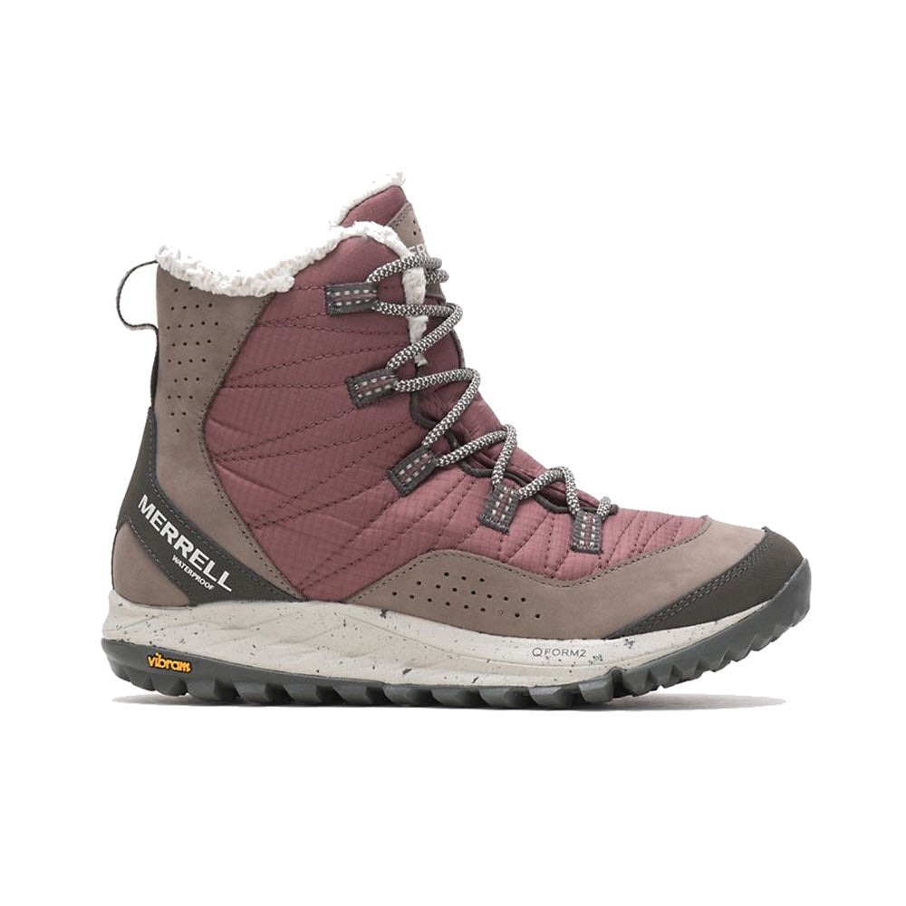 The Merrell Antora Sneaker Boot Marron for women is a high-top winter sneaker boot featuring a maroon and gray exterior, a white speckled midsole, and a black durable outsole designed for cold-weather conditions. It boasts gray laces and proudly displays the Merrell logo on the side.