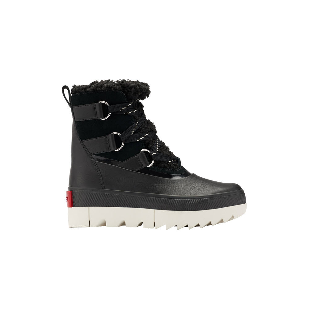 A SOREL JOAN OF ARCTIC NEXT BOOT BLACK - WOMENS from Sorel with black laces, a fuzzy lining, and a white, high-traction sole. The boot features three metal lace loops and a red heel tag.