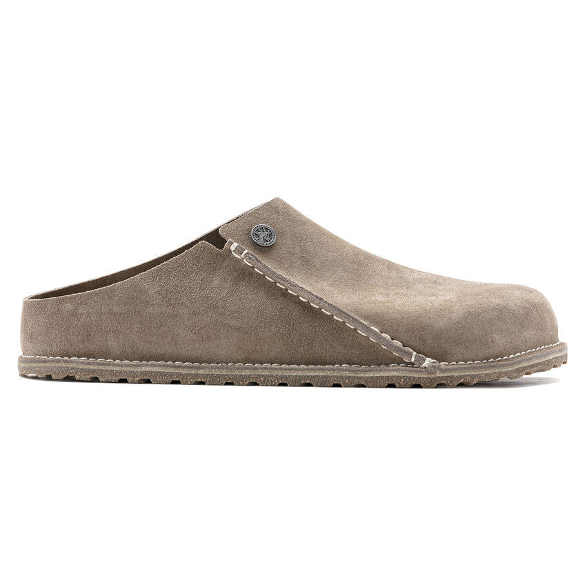 A side view of a beige, slip-on Birkenstock BIRKENSTOCK ZERMATT 365 GRAY TAUPE - WOMENS clog shoe with a thick rubber cork blend sole and visible stitching along the sides and top.