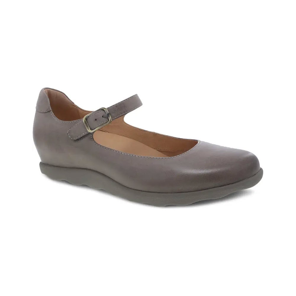 A single taupe Mary Jane shoe from Dansko, known as the DANSKO MARCELLA TAUPE BURNISHED - WOMENS, with a strap and buckle, featuring a rounded toe and hidden wedge heel, set against a white background.