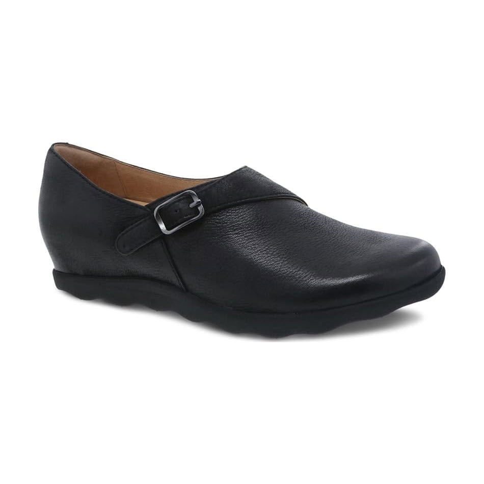 The DANSKO MARISA BLACK BURNISHED for women by Dansko features a single black leather shoe with a low wedge heel, a small buckle strap across the top, and a comfortable memory foam footbed.