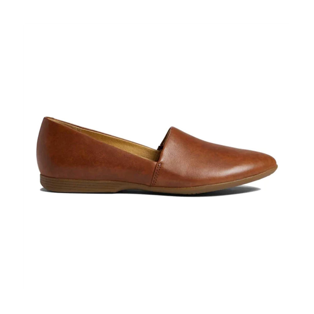 A side view of the DANSKO LARISA SADDLE - WOMENS, a brown slip-on flat leather shoe by Dansko, featuring leather uppers and a closed toe with arch support, set against a white background.