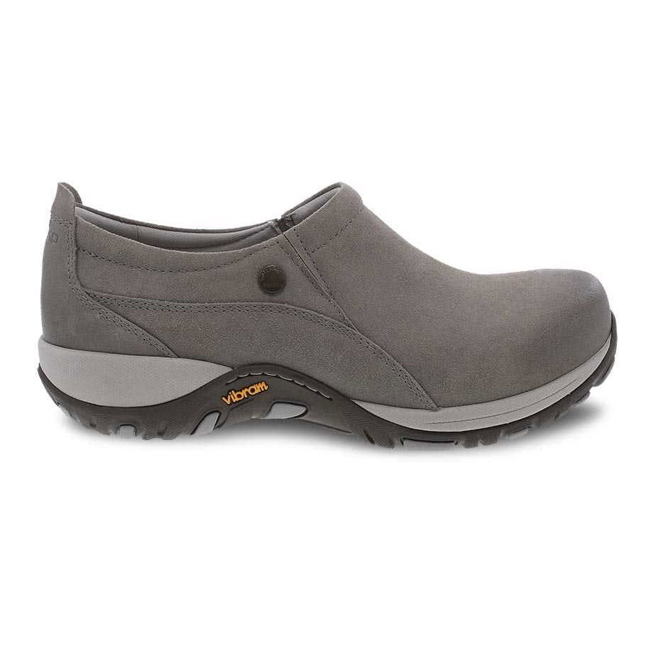 Introducing the DANSKO PATTI TAUPE BURNISHED - WOMENS: a single taupe slip-on shoe with a rubber sole, featuring a small circular design detail on the side and marked with a Dansko logo on the slip-resistant sole—ideal for outdoor activities.