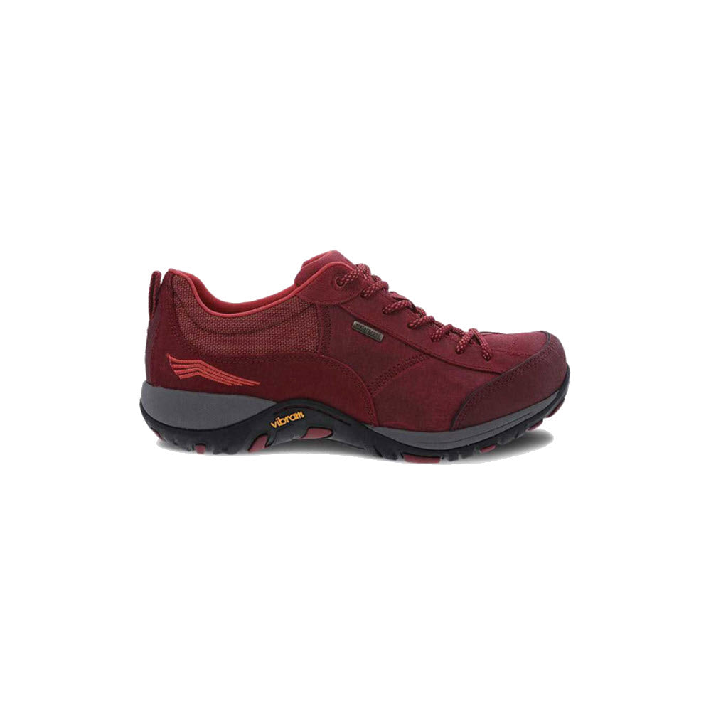 The Dansko Paisley Red Burnished walking shoe for women features a lace-up design, sport-inspired style, low cut, textured Vibram rubber outsole, and branding on the side and midsole.