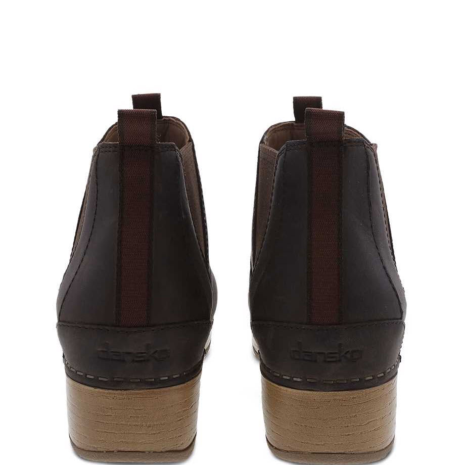 A rear view of a pair of brown Dansko Becka Brown - Womens with short heels and pull tabs, perfect for your fall/winter wardrobe. Slide into comfort and embrace the timeless Dansko style.