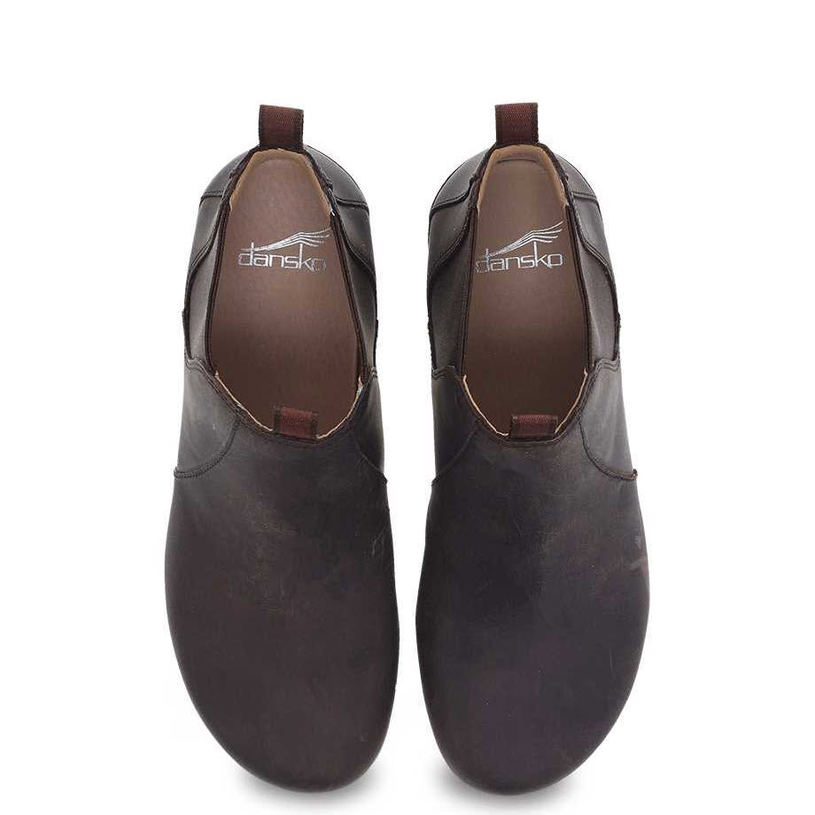 A pair of DANSKO BECKA BROWN - WOMENS shoes with Dansko branding on the inner soles, perfect to slide into comfort and elevate your fall/winter wardrobe.