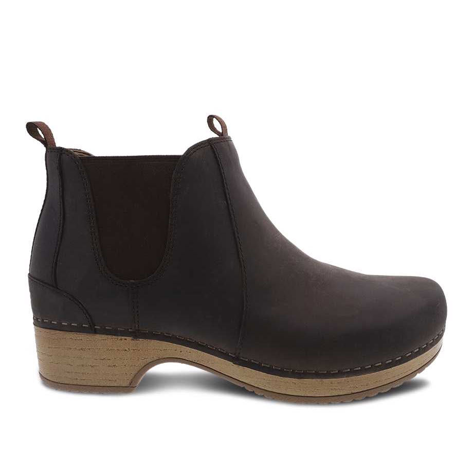 A single DANSKO BECKA BROWN - WOMENS from Dansko with a low wooden heel and elastic side panels, perfect for adding comfort to your fall/winter wardrobe.