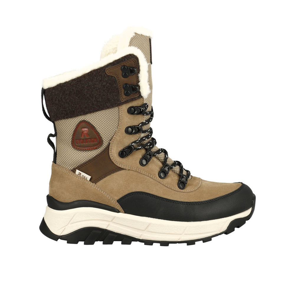 The Revolution Women's Winter Boot Wool Cuff Brown is a tan and black winter adventure boot with a faux fur lining, lace-up front, rugged Fiber-Grip sole, and reinforced toe. It also features a small red logo patch near the ankle.