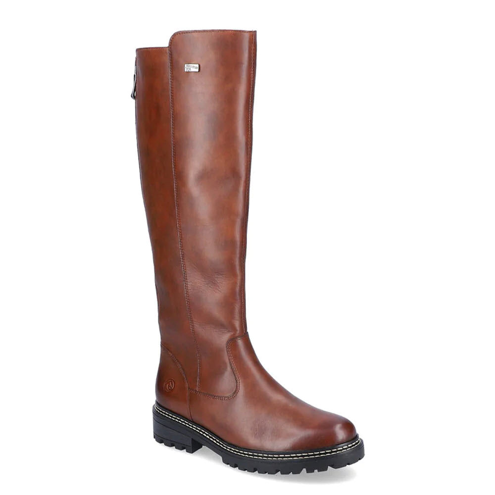 The REMONTE LUG SOLE TALL BOOT TAN for women by Remonte is a single tall tan leather boot with a black rubber sole, side zip closure, and velour lining for added comfort.