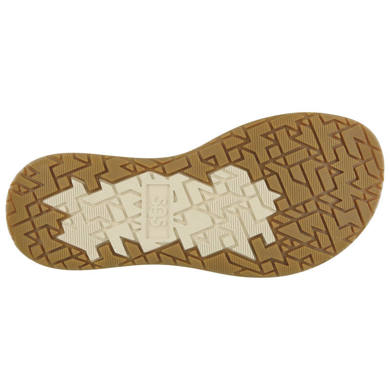 A close-up view of the shock-absorbing sole of the SAS Embark Sandal Live Oak for women, featuring a tan and white patterned tread with the letters &quot;SAS&quot; imprinted in the center.