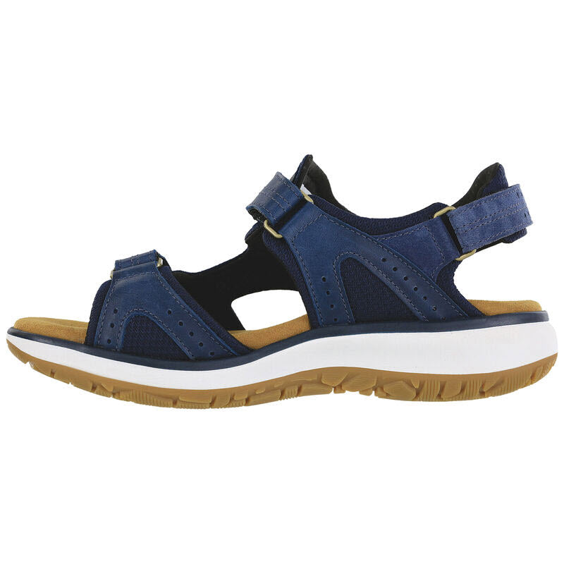 A blue and beige open-toe outdoorsy sandal with adjustable straps, a cushioned insole, and a white, brown-tread rubber sole, viewed from the side. The product is the SAS EMBARK SANDAL NEPTUNE - WOMENS from SAS.