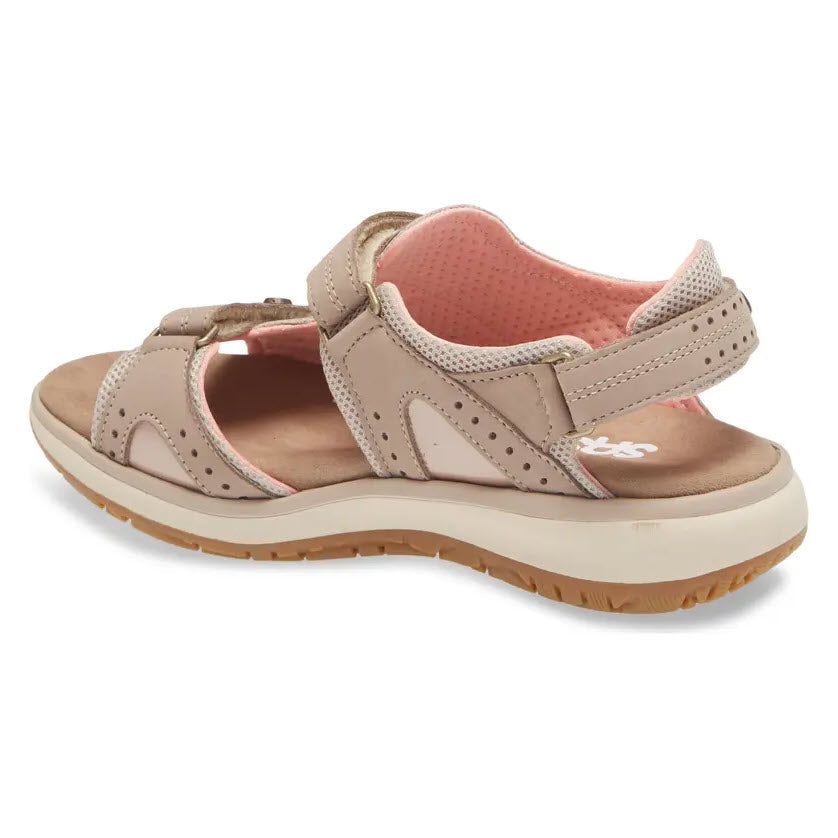 SAS EMBARK SANDAL TAUPE - WOMENS by SAS features beige leather with a pink interior lining, perforated design elements, adjustable straps, and a cushioned insole. The sandal has a rugged tread pattern suited for outdoor use.