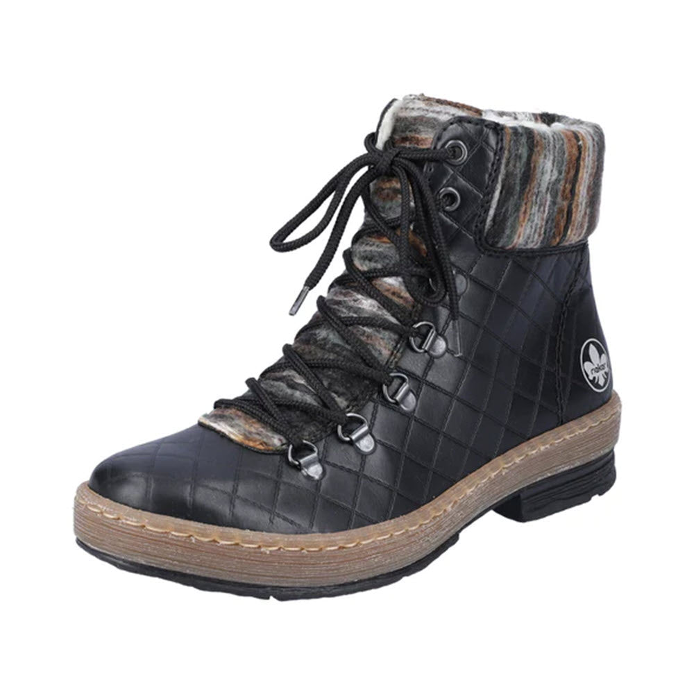 The RIEKER YARN CUFF LACE UP BOOTIE BLACK by Rieker is a black quilted winter ankle boot with a lace-up front, warm fur lining, and a multicolored cuff. The boot features a brown sole with stitching detail and a small circular logo on the side.