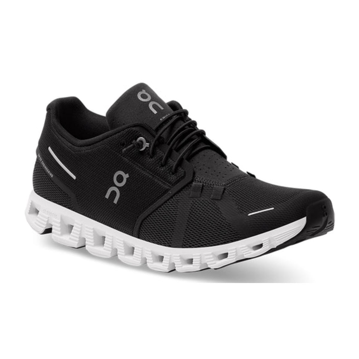 Black and white athletic shoe with a mesh upper, branded with &quot;On Running&quot; logo on the side and tongue, featuring CloudTec® technology for a distinctive cushioned, segmented sole and a speed lacing system for quick adjustments: the ON CLOUD 5 BLACK/WHITE - MENS.