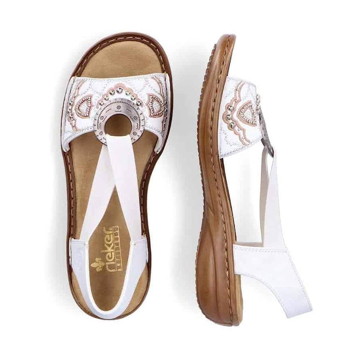 Top and side view of the RIEKER SLINGBACK FLAT WITH ORNAMENT WHITE - WOMENS, by Rieker, featuring ornate embroidery and a buckle strap. These sandals also have cushioned brown insoles and tan outsoles.