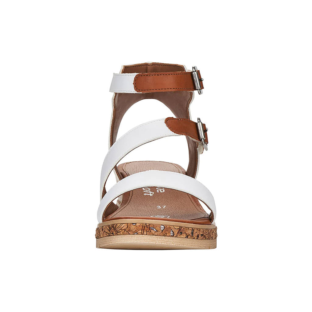 Front view of the Remonte women&#39;s REMONTE ASYMMETRICAL STRAPPY WEDGE in white, featuring asymmetrical crisscross straps, brown adjustable ankle straps with buckles, and a cork sole.