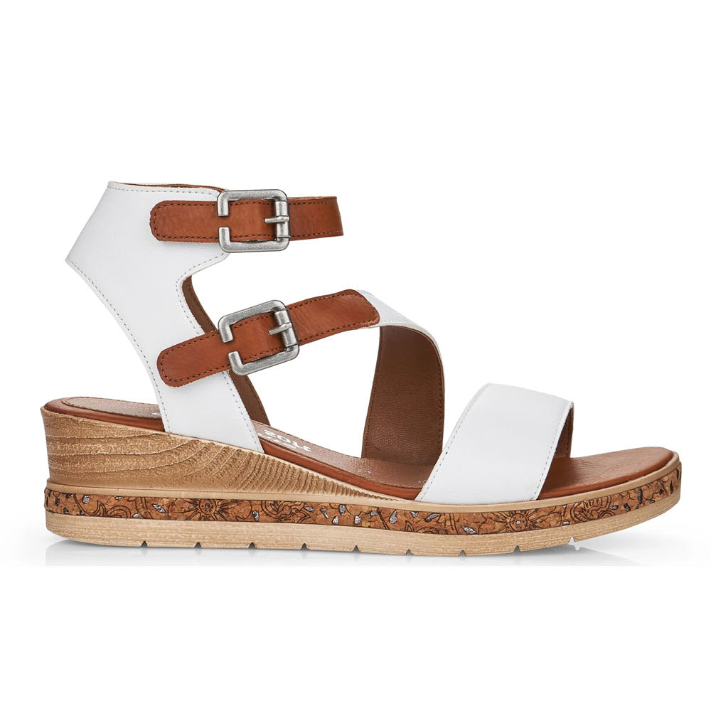 The REMONTE ASYMMETRICAL STRAPPY WEDGE WHITE for women by Remonte is a white and brown Antistress sandal with decorative straps, metal buckles, and a multilevel wedge heel featuring a floral pattern.