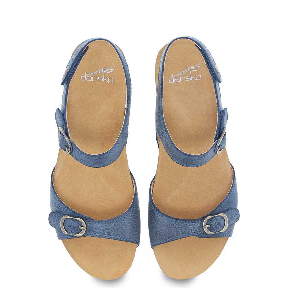 The DANSKO TRICIA BLUE - WOMENS sandals by Dansko feature buckled straps and open toes viewed from above, with a contoured footbed providing premium comfort. They’re perfect as a warm-weather sandal.