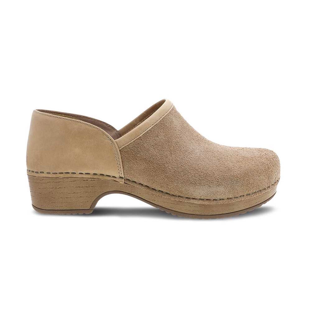 The DANSKO BRENNA SAND SUEDE - WOMENS by Dansko is a tan suede clog shoe with a low heel and closed, rounded toe, designed as a casual slip-on featuring stain resistance.