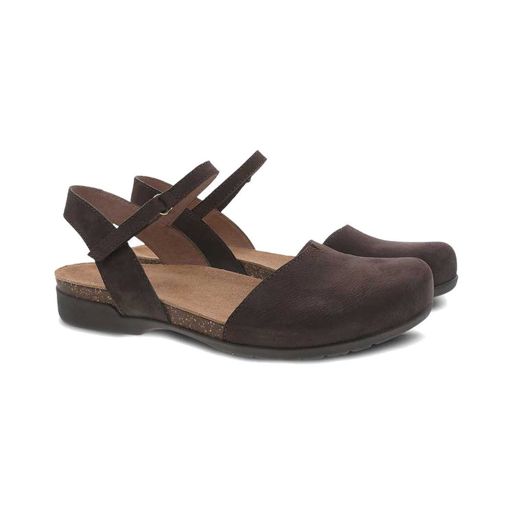 The DANSKO ROWAN CHOCOLATE for women by Dansko is a pair of dark brown leather hybrid sandals with closed toes and adjustable straps, shown in a side view, perfect for completing your summer look.