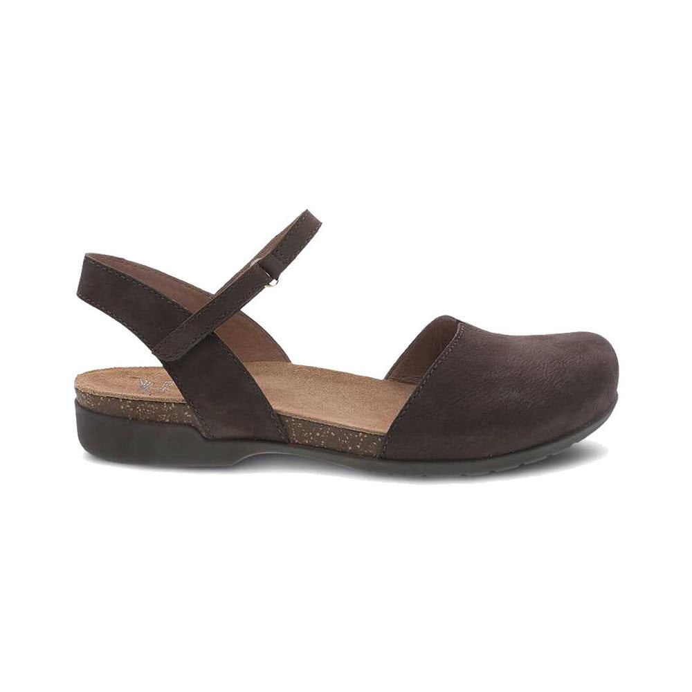 Profile view of a Dansko Rowan Chocolate sandal for women featuring a dark brown closed toe, a single strap over the foot, and a back strap. This hybrid sandal combines a flat sole with slight arch support, making it perfect for a stylish summer look.