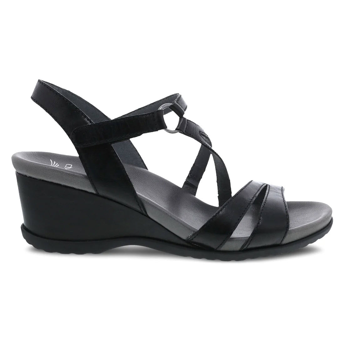 The DANSKO ADDYSON GLAZED BLACK - WOMENS from Dansko is a stylish black women&#39;s wedge sandal featuring multiple straps made from chrome-free leather and a convenient Velcro closure at the ankle. It includes a slightly textured sole with a contoured EVA footbed for enhanced comfort and has a moderately high heel.