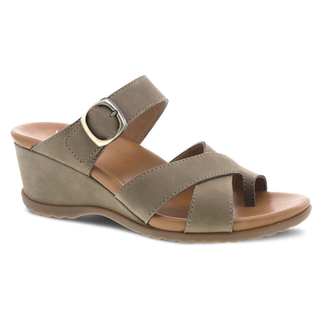 Introducing the Dansko Aubree Taupe Nubuck - Women&#39;s, a stylish wedge heel sandal featuring a taupe nubuck upper. It comes with an ankle strap buckle and a peep-toe design, complemented by a leather-wrapped footbed for enhanced comfort.