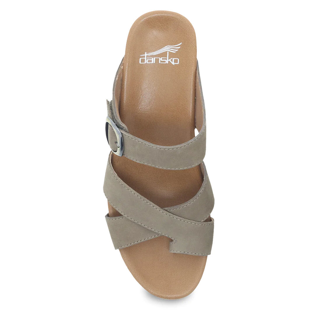 Top view of the Dansko Aubree Taupe Nubuck wedge sandal showcasing a beige nubuck upper with a crisscross leather strap design and a metallic buckle, featuring the brand &quot;Dansko&quot; on the leather-wrapped footbed.