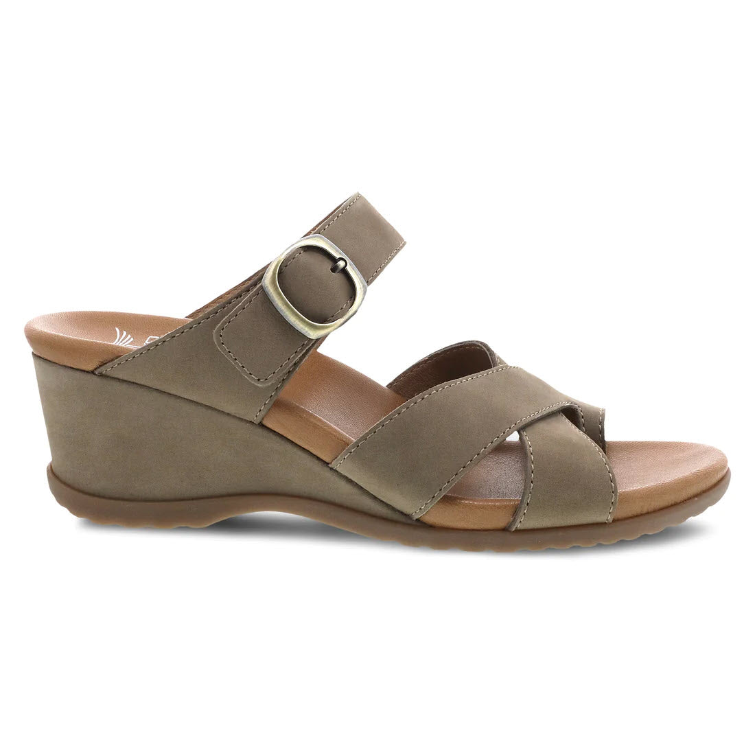 A side view of the Dansko Aubree Taupe Nubuck women&#39;s wedge sandal, showcasing two straps with a buckle, nubuck uppers, a leather-wrapped footbed, a low wedge heel, and a durable rubber sole.