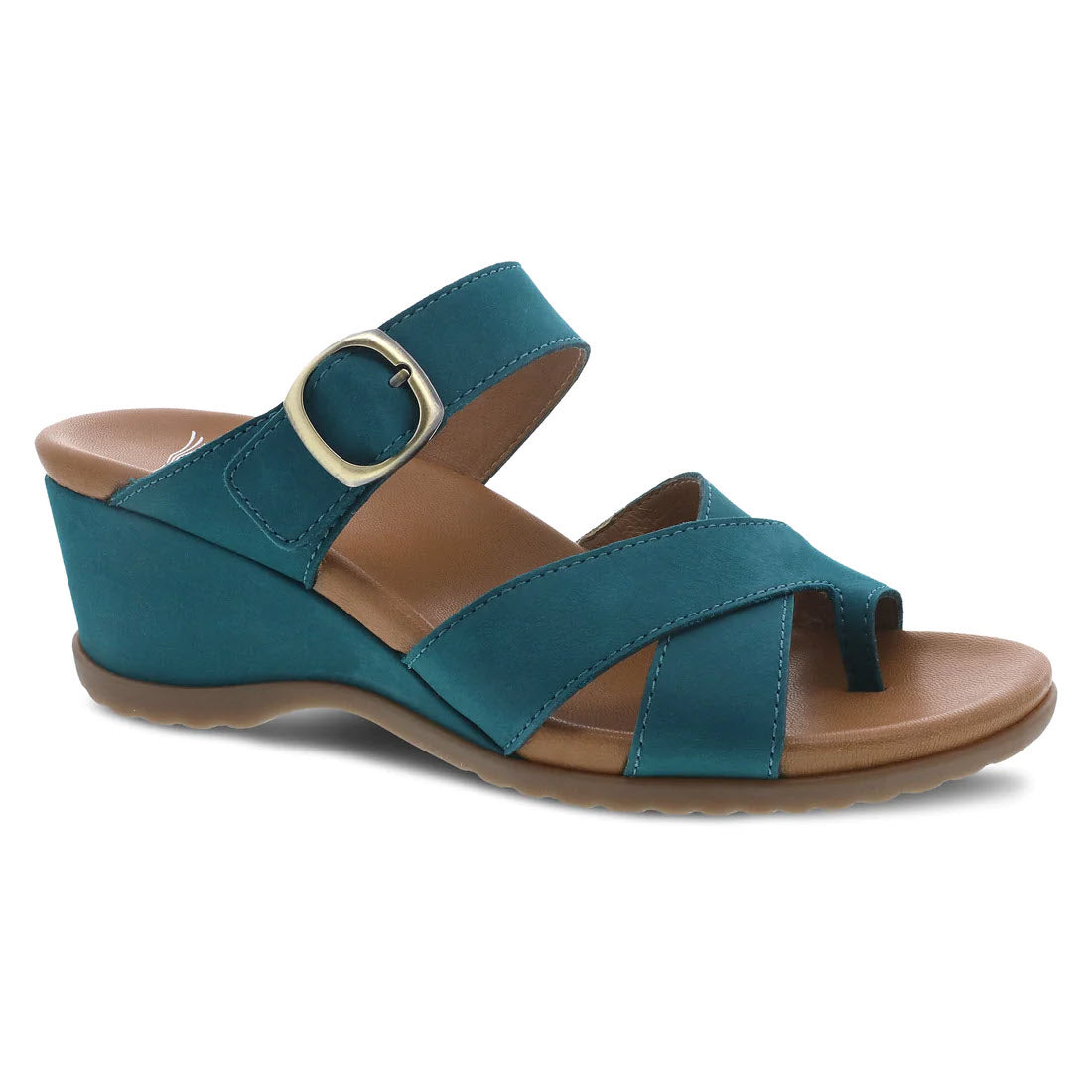 The DANSKO AUBREE TEAL NUBUCK - WOMENS by Dansko is a teal open back wedge sandal featuring nubuck uppers with a wide strap and buckle across the top, an open toe, and a tan leather-wrapped contoured EVA footbed.