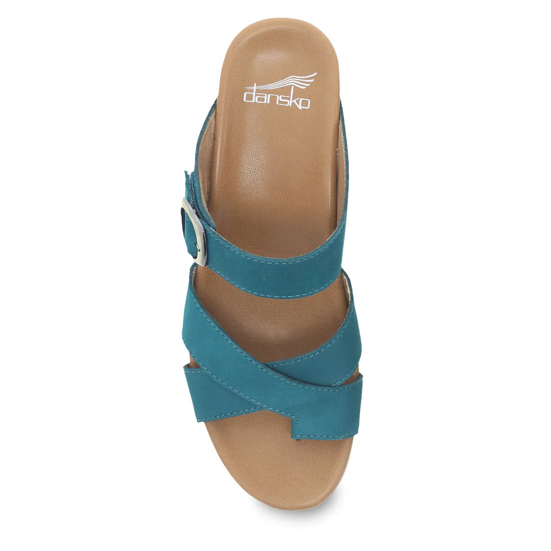 Introducing the DANSKO AUBREE TEAL NUBUCK for women, a stylish slide sandal featuring a teal nubuck upper with crossing straps and a side buckle. The insole proudly displays the Dansko logo, and it boasts a leather-wrapped contoured EVA footbed for ultimate comfort.