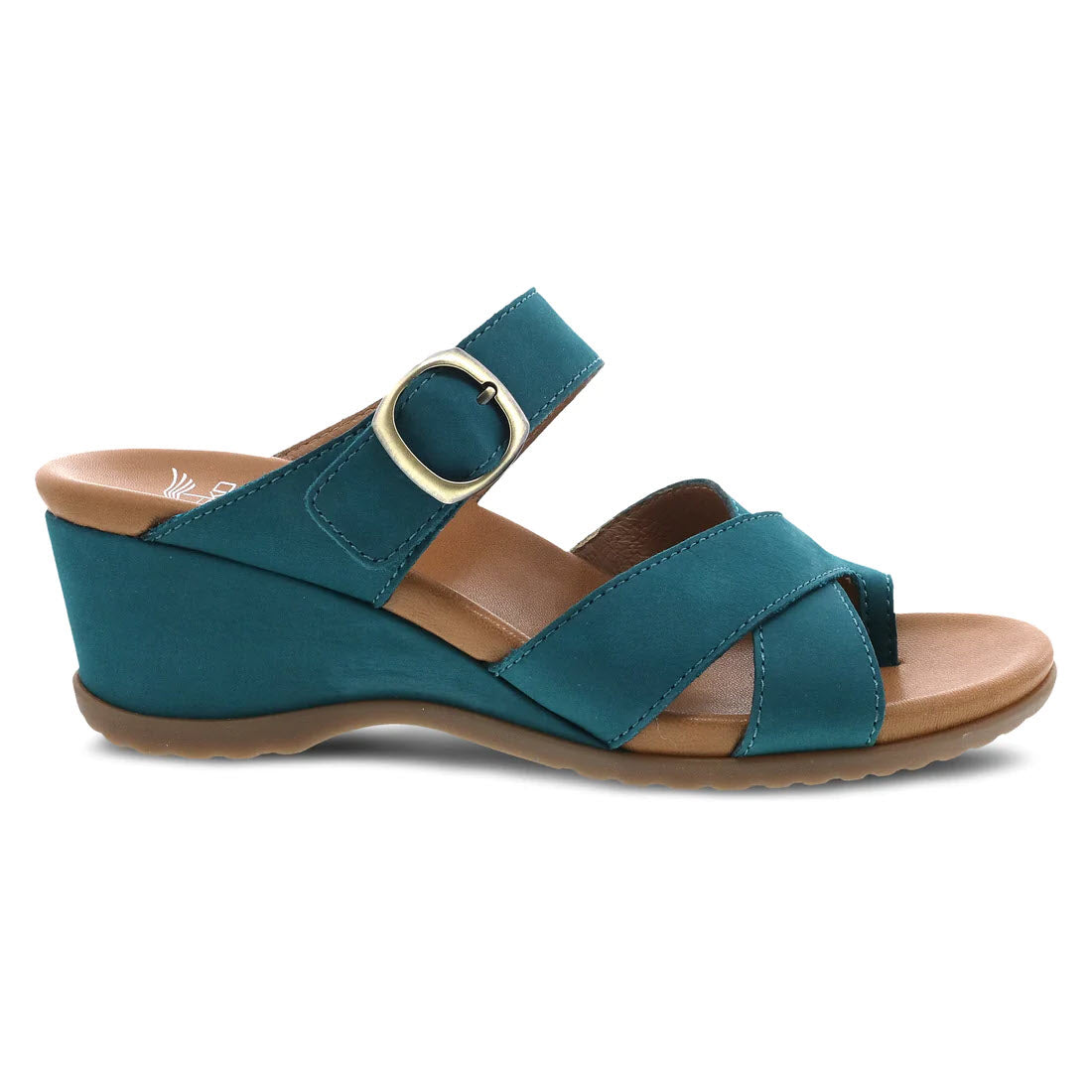 The Dansko Aubree Teal Nubuck women&#39;s sandals feature nubuck uppers, a thick strap with a gold buckle, two crossed front straps, an open back, and a tan cushioned footbed.