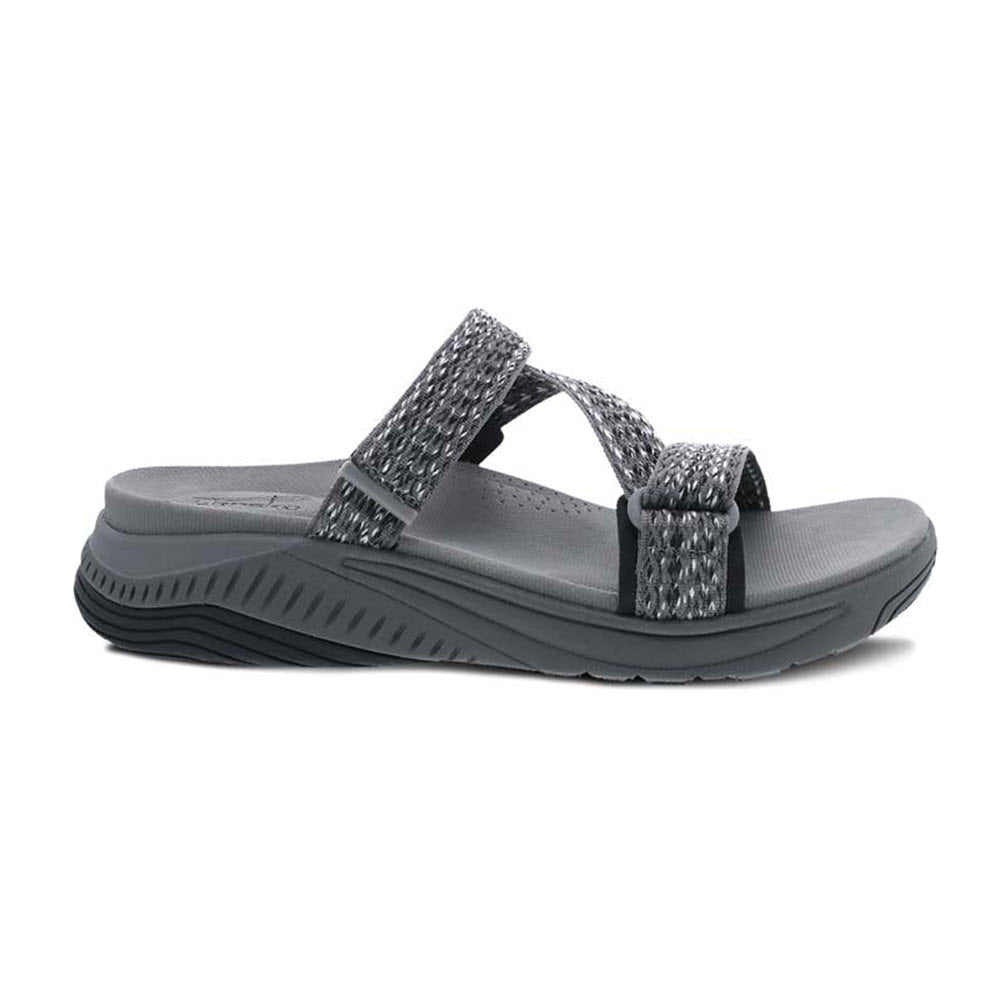 The DANSKO ROSETTE GREY MULTI - WOMENS by Dansko features grey open-toe sandals with textured straps and a cushioned sole for enhanced comfort, viewed from the side. Perfect as your go-to sandals for performance walking shoes.