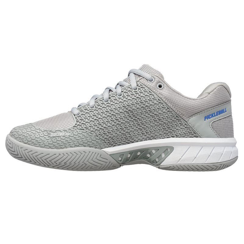 A side view of the K-Swiss Express Light Pickleball Highrise Gray shoe for women, featuring a lightweight and breathable knitted mesh upper in gray. The lace-up closure ensures a secure fit, while &quot;PICKLEBALL&quot; is prominently displayed on the heel. The durable rubber outsole with a herringbone pattern provides excellent grip.