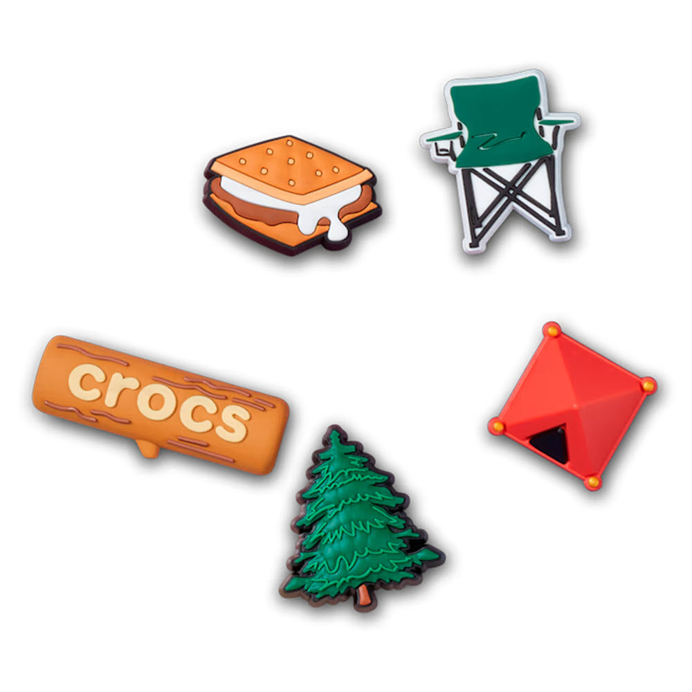 Five colorful CROCS JIBBITZ 5 PACK CAMPING charms featuring a s&#39;more, a green camping chair, a brown log with &quot;crocs&quot; text, a green pine tree, and a red tent—perfect clogs and slides accessories by Crocs.