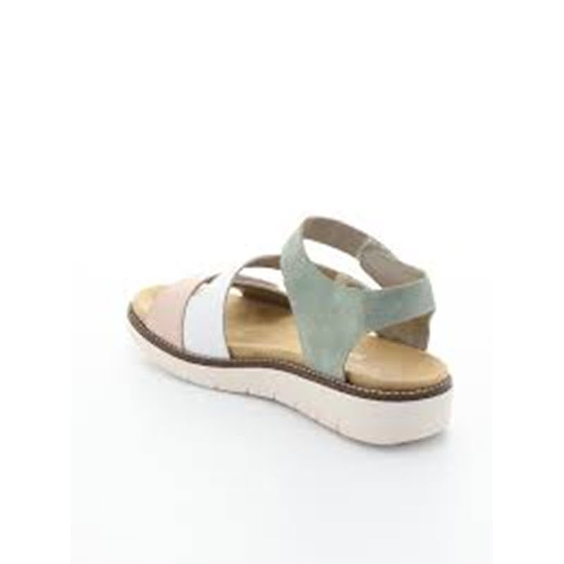 The REMONTE ASYMMETRICAL SANDAL PASTEL MULTI - WOMENS is showcased from a rear angle against a neutral background, highlighting its flat white sole and asymmetrical multicolored straps in white, blue, and beige. The renowned soft Remonte insole promises all-day comfort.