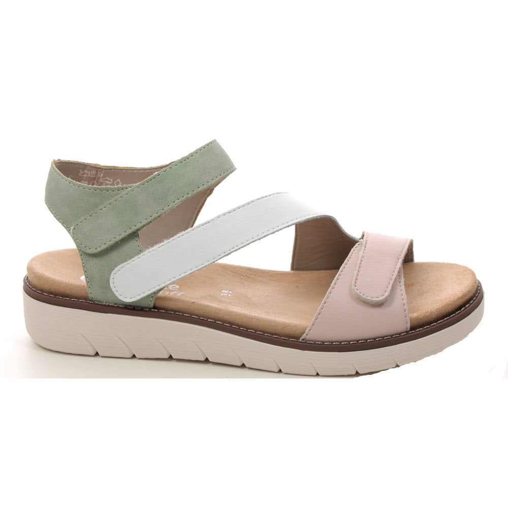 A casual REMONTE ASYMMETRICAL SANDAL PASTEL MULTI - WOMENS with green, white, and pink straps. It features a cushioned Remonte insole, adjustable hook-and-loop straps, and a thick rubber sole.